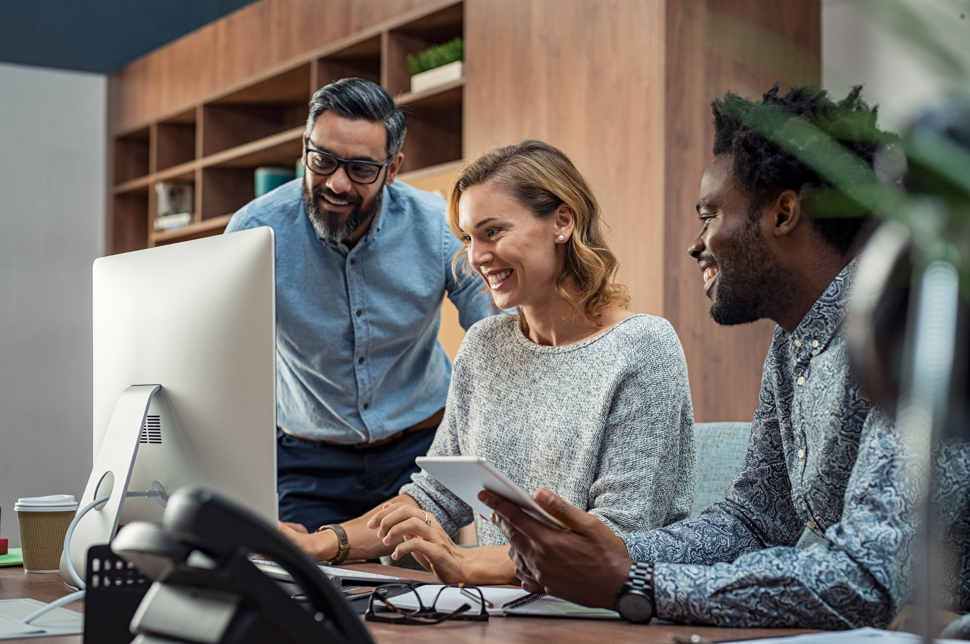 people smiling working at desk