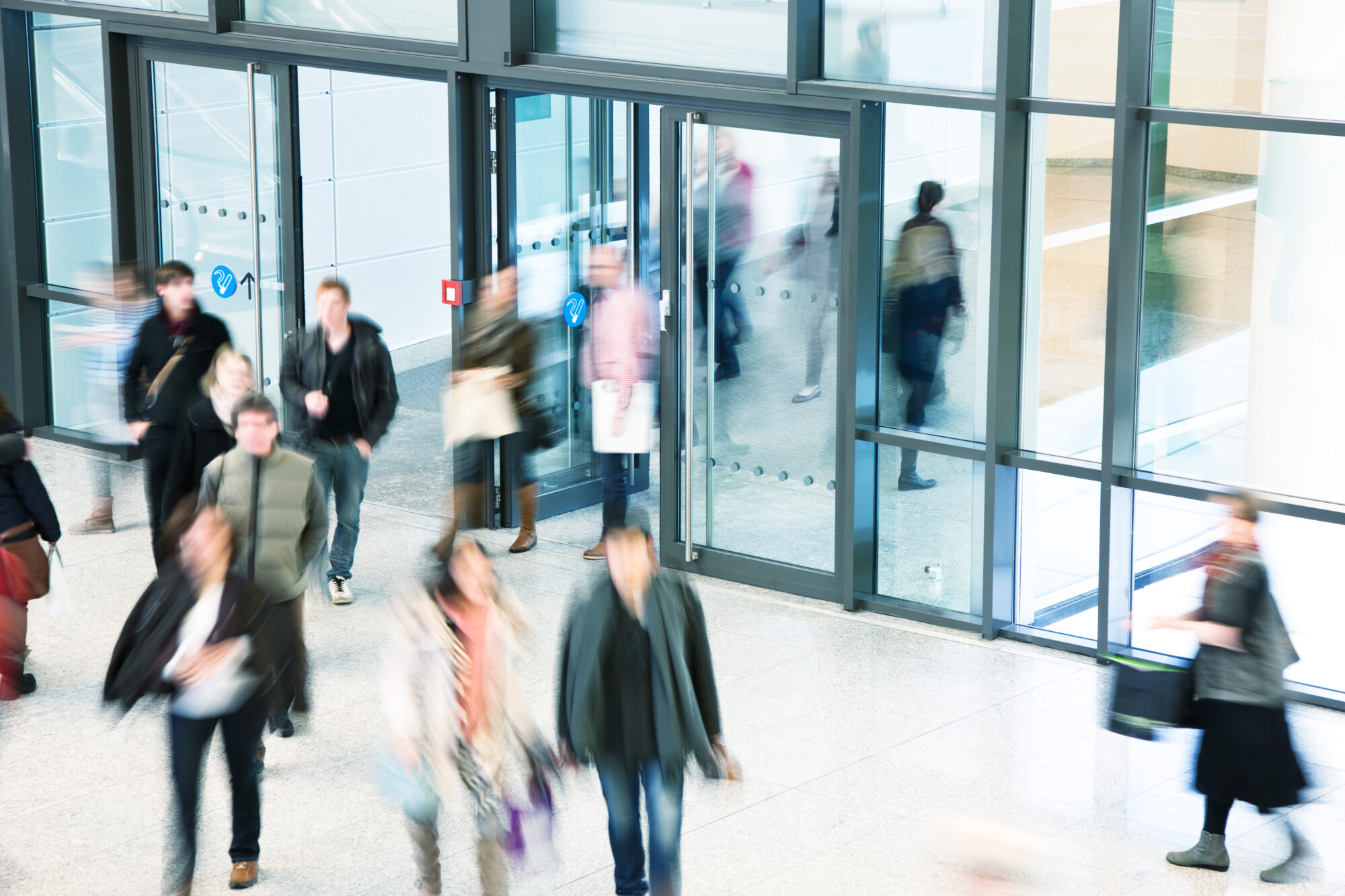 people in motion in and out of a building