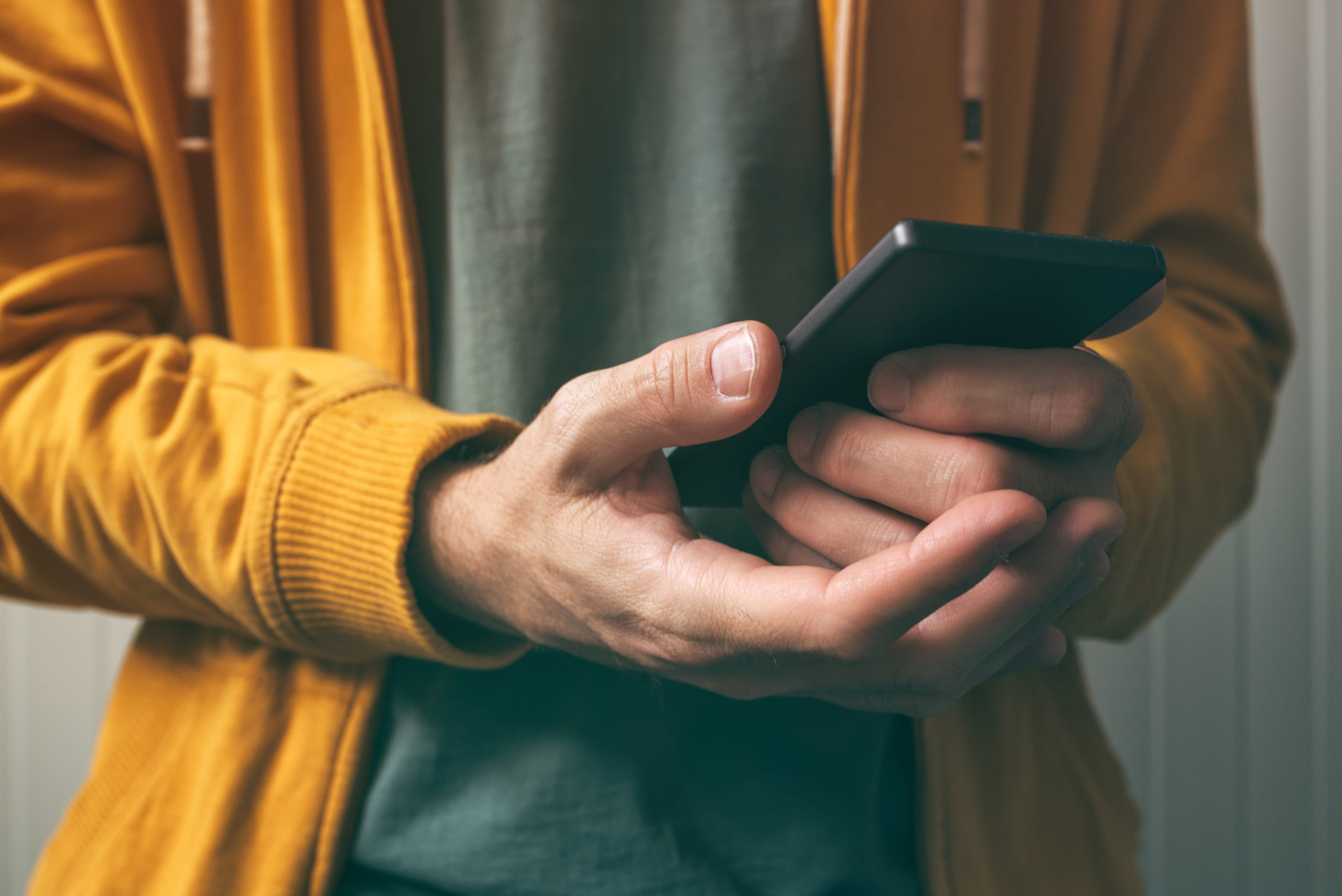 man holding phone with two hands